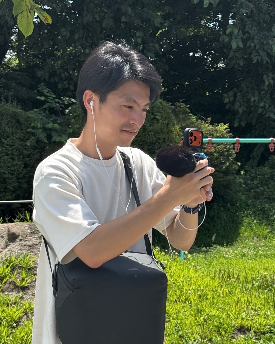 スマートフォンで撮影する代表社員 尾野喬祐